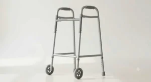 A standard grey Zimmer frame with front wheels, ideal as a walking frame after hip replacement for stable indoor mobility.