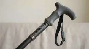 Close-up of the height-adjustable handle and grip on a large base quad cane
